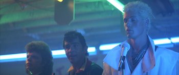 Movie still from “The Adventures of Buckaroo Banzai Across the 8th Dimension” (1984), directed by W.D. Richter – Two men standing next to each other in a room; Close Up shot, Low angle