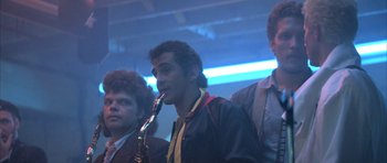 Movie still from “The Adventures of Buckaroo Banzai Across the 8th Dimension” (1984), directed by W.D. Richter – A group of men standing next to each other; Medium shot, Low angle
