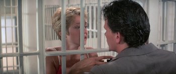 Movie still from “The Adventures of Buckaroo Banzai Across the 8th Dimension” (1984), directed by W.D. Richter – A man and a woman in a jail cell; Close Up shot, Over the shoulder angle