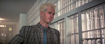 A man with blonde hair wearing a plaid shirt