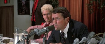Movie still from “The Adventures of Buckaroo Banzai Across the 8th Dimension” (1984), directed by W.D. Richter – A man and a woman sitting in front of microphones; Close Up shot, Over the shoulder angle