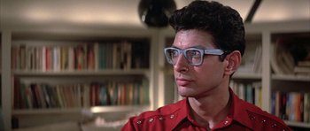 Movie still from “The Adventures of Buckaroo Banzai Across the 8th Dimension” (1984), directed by W.D. Richter – A man wearing glasses and looking to his left; Close Up shot, Low angle