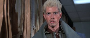 Movie still from “The Adventures of Buckaroo Banzai Across the 8th Dimension” (1984), directed by W.D. Richter – A person wearing a shirt and jacket; Close Up shot, Low angle