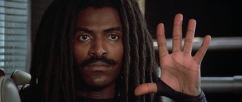Movie still from “The Adventures of Buckaroo Banzai Across the 8th Dimension” (1984), directed by W.D. Richter – A person with dreads; Close Up shot, Low angle