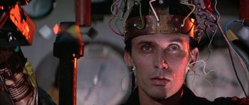 Movie still from “The Adventures of Buckaroo Banzai Across the 8th Dimension” (1984), directed by W.D. Richter – A person with wires on their head; Close Up shot, Low angle