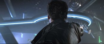 Movie still from “The Adventures of Ford Fairlane” (1990), directed by Renny Harlin – A man wearing a leather jacket looking out a window; Close Up shot, Over the shoulder angle