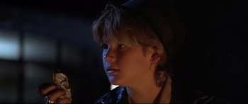 Movie still from “The Adventures of Ford Fairlane” (1990), directed by Renny Harlin – A young boy is looking into the distance; Close Up shot, Over the shoulder angle