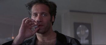 Movie still from “The Adventures of Ford Fairlane” (1990), directed by Renny Harlin – A person brushing his teeth; Close Up shot, Low angle