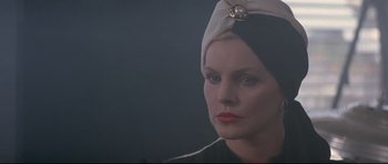 Movie still from “The Adventures of Ford Fairlane” (1990), directed by Renny Harlin – Charlize theron wearing a headscarf; Close Up shot, Low angle