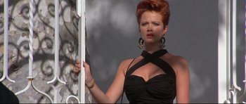 Movie still from “The Adventures of Ford Fairlane” (1990), directed by Renny Harlin – A woman with red hair and a black dress; Close Up shot, Low angle