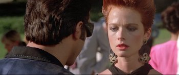 Movie still from “The Adventures of Ford Fairlane” (1990), directed by Renny Harlin – A man and a woman looking at one another; Close Up shot, Over the shoulder angle