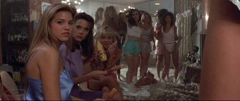 Movie still from “The Adventures of Ford Fairlane” (1990), directed by Renny Harlin – A group of women standing next to each other in a room; Medium shot, Low angle