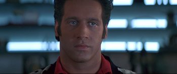 Movie still from “The Adventures of Ford Fairlane” (1990), directed by Renny Harlin – A man's face in front of a window; Close Up shot, Low angle