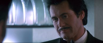 Movie still from “The Adventures of Ford Fairlane” (1990), directed by Renny Harlin – A person wearing a suit and tie; Close Up shot, Low angle