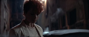 Movie still from “The Adventures of Ford Fairlane” (1990), directed by Renny Harlin – A person with red hair looking down; Close Up shot, Low angle