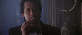 Movie still from “The Adventures of Ford Fairlane” (1990), directed by Renny Harlin – A person wearing a suit and tie; Close Up shot, Low angle