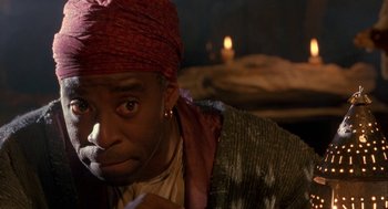 Movie still from “The Adventures of Huck Finn” (1993), directed by Stephen Sommers – A man with a red turban on his head; Close Up shot, Over the shoulder angle