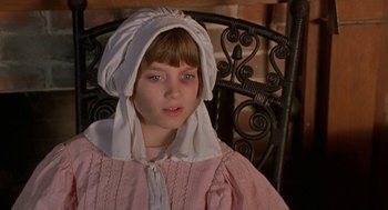 Movie still from “The Adventures of Huck Finn” (1993), directed by Stephen Sommers – A young girl wearing a pink dress and a white hat; Close Up shot, High angle