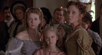 Movie still from “The Adventures of Huck Finn” (1993), directed by Stephen Sommers – A group of people standing next to each other in a room; Close Up shot, Low angle