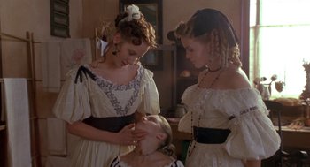Movie still from “The Adventures of Huck Finn” (1993), directed by Stephen Sommers – Three young women in old - fashioned dresses are looking at a young girl's face; Medium shot, Over the shoulder angle