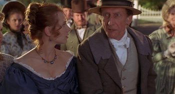 Movie still from “The Adventures of Huck Finn” (1993), directed by Stephen Sommers – A man and a woman are standing next to each other; Close Up shot, Over the shoulder angle