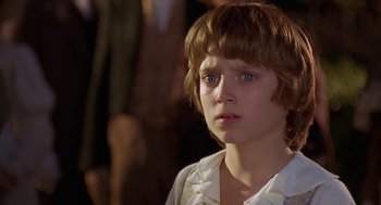 Movie still from “The Adventures of Huck Finn” (1993), directed by Stephen Sommers – A young boy is looking into the distance; Close Up shot, Over the shoulder angle
