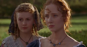Movie still from “The Adventures of Huck Finn” (1993), directed by Stephen Sommers – Two young women standing next to each other in a field; Close Up shot, Over the shoulder angle