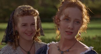 Movie still from “The Adventures of Huck Finn” (1993), directed by Stephen Sommers – Two young women standing next to each other in a field; Close Up shot, Over the shoulder angle