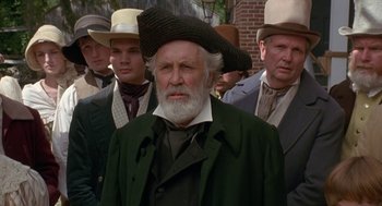 Movie still from “The Adventures of Huck Finn” (1993), directed by Stephen Sommers – An old man with a long beard wearing a hat; Close Up shot, Low angle