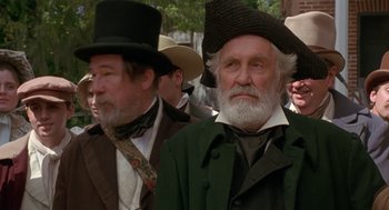 Movie still from “The Adventures of Huck Finn” (1993), directed by Stephen Sommers – A man with long white beard wearing a top hat; Close Up shot, Low angle