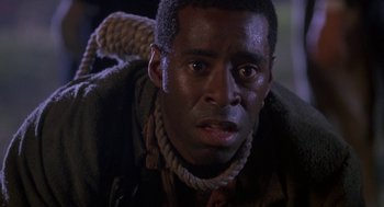 Movie still from “The Adventures of Huck Finn” (1993), directed by Stephen Sommers – A person with a rope around his neck; Close Up shot, Low angle
