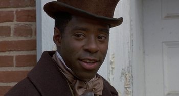 Movie still from “The Adventures of Huck Finn” (1993), directed by Stephen Sommers – A person wearing a top hat; Close Up shot, Low angle
