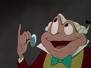 Movie still from “The Adventures of Ichabod and Mr. Toad” (1949), directed by Jack Kinney – An animated character holding a remote control in his hand; Close Up shot, Overhead angle