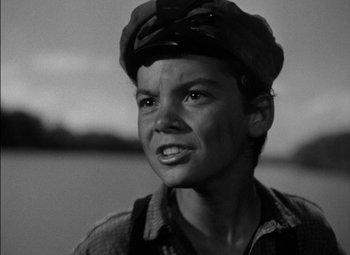 Movie still from “The Adventures of Mark Twain” (1944), directed by Irving Rapper – A young man wearing a hat and a shirt; Close Up shot, High angle