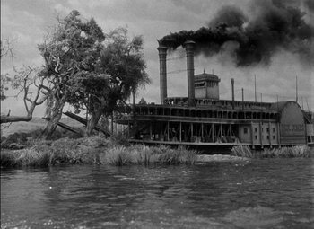 Movie still from “The Adventures of Mark Twain” (1944), directed by Irving Rapper – A river with a boat on it near a tree; Extreme Wide shot, Low angle