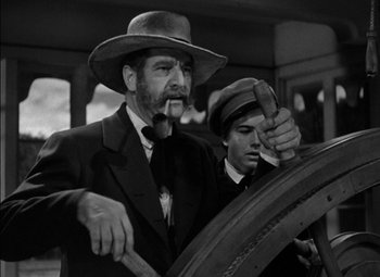 Movie still from “The Adventures of Mark Twain” (1944), directed by Irving Rapper – A man in a suit and a man in a hat; Medium shot, Low angle