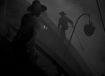 Movie still from “The Adventures of Mark Twain” (1944), directed by Irving Rapper – Two men in hats are standing in the fog; Wide shot, Low angle