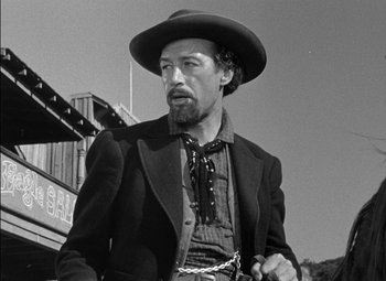 Movie still from “The Adventures of Mark Twain” (1944), directed by Irving Rapper – A black and white photo of a man wearing a cowboy hat; Medium shot, Low angle