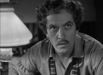 Movie still from “The Adventures of Mark Twain” (1944), directed by Irving Rapper – Black and white photograph of a man in a plaid shirt; Close Up shot, High angle