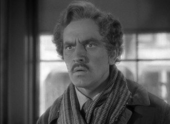Movie still from “The Adventures of Mark Twain” (1944), directed by Irving Rapper – An old photo of a man with a mustache wearing a scarf; Close Up shot, Over the shoulder angle