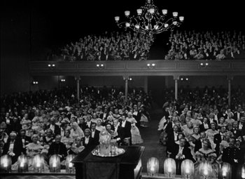 Movie still from “The Adventures of Mark Twain” (1944), directed by Irving Rapper – A large group of people sitting in front of candles; Extreme Wide shot, High angle