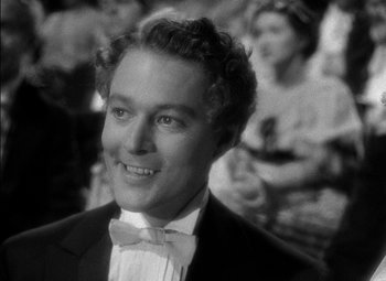 Movie still from “The Adventures of Mark Twain” (1944), directed by Irving Rapper – A black and white photo of a man in a tuxedo; Close Up shot, Over the shoulder angle