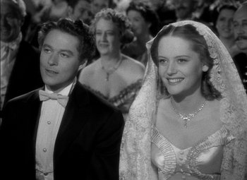 Movie still from “The Adventures of Mark Twain” (1944), directed by Irving Rapper – A black and white photo of a bride and groom; Medium shot, Low angle