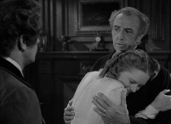 Movie still from “The Adventures of Mark Twain” (1944), directed by Irving Rapper – An older man and a young girl hug in a room; Medium shot, Over the shoulder angle