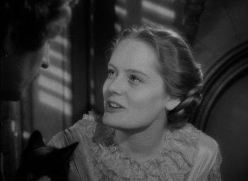 Movie still from “The Adventures of Mark Twain” (1944), directed by Irving Rapper – A young woman in a white dress is looking at the camera; Close Up shot, Over the shoulder angle