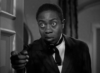 Movie still from “The Adventures of Mark Twain” (1944), directed by Irving Rapper – A black and white photo of a man in a suit and tie; Close Up shot, High angle