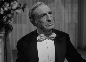 Movie still from “The Adventures of Mark Twain” (1944), directed by Irving Rapper – An older man wearing a tuxedo and a bow tie; Close Up shot, Low angle