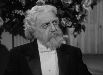 Movie still from “The Adventures of Mark Twain” (1944), directed by Irving Rapper – An old man with a beard wearing a suit and bow tie; Close Up shot, Over the shoulder angle