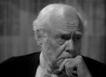 Movie still from “The Adventures of Mark Twain” (1944), directed by Irving Rapper – An old man with a beard is sitting with his chin resting on his hands; Close Up shot, High angle