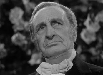 Movie still from “The Adventures of Mark Twain” (1944), directed by Irving Rapper – An older man wearing a suit and bow tie; Close Up shot, Low angle